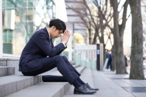 Japanese male businessmen suffering from anxiety.
